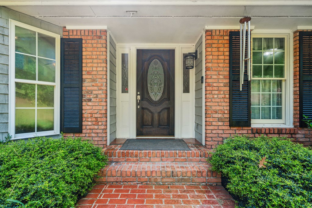 5055 Wright Bridge Road Cumming, GA 30028 - Photo 36 of 39 a front view of a house with a garden