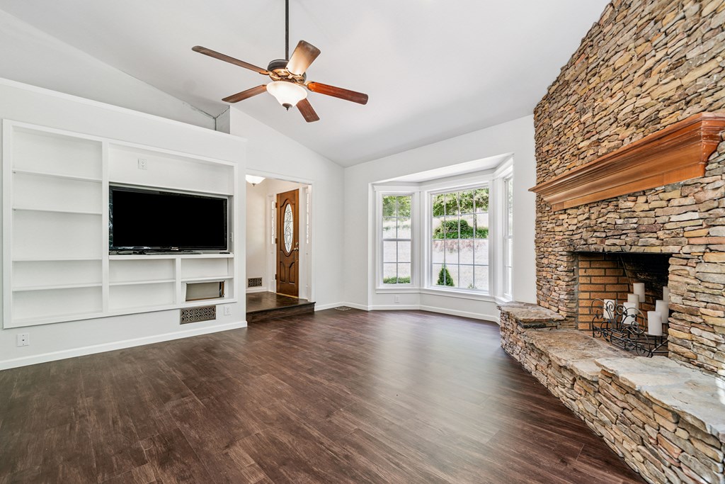5055 Wright Bridge Road Cumming, GA 30028 - Photo 4 of 39 a living room with furniture fireplace and flat screen tv