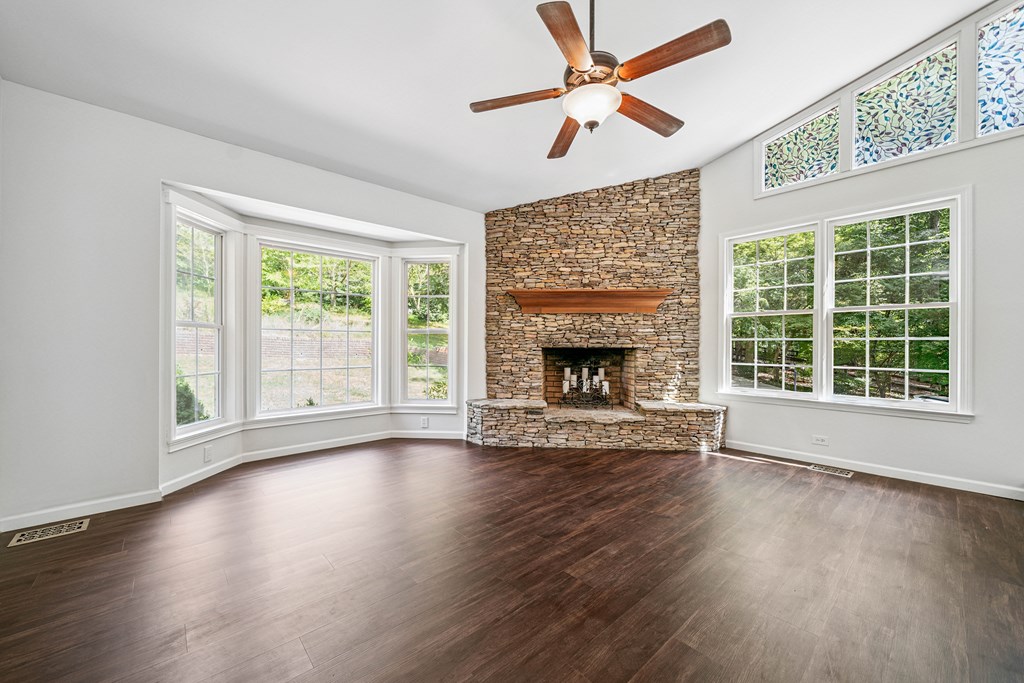 5055 Wright Bridge Road Cumming, GA 30028 - Photo 6 of 39 a view of an empty room with wooden floor and a fireplace