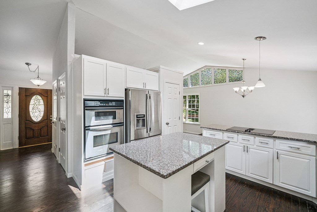 5055 Wright Bridge Road Cumming, GA 30028 - Photo 9 of 39 a kitchen with a sink a center island and stainless steel appliances