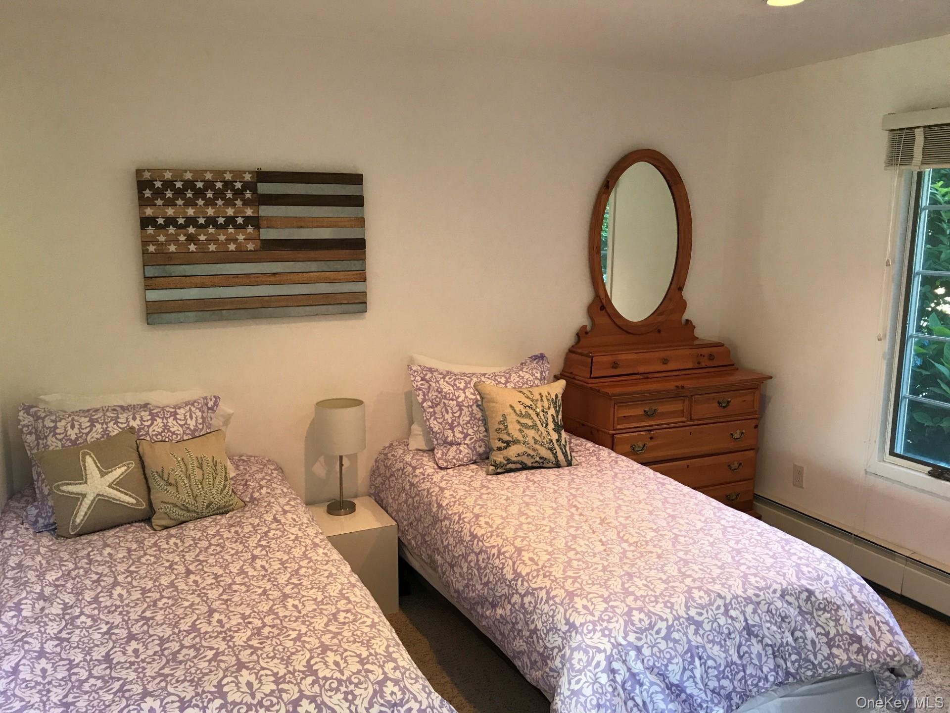 42 Towd Point Road Southampton, NY 11968 - Photo 11 of 26 a bedroom with a bed a dresser and a window