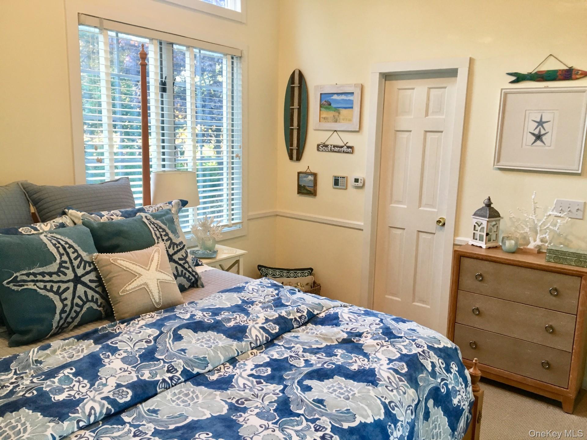 42 Towd Point Road Southampton, NY 11968 - Photo 13 of 26 a bedroom with a bed and wooden floor