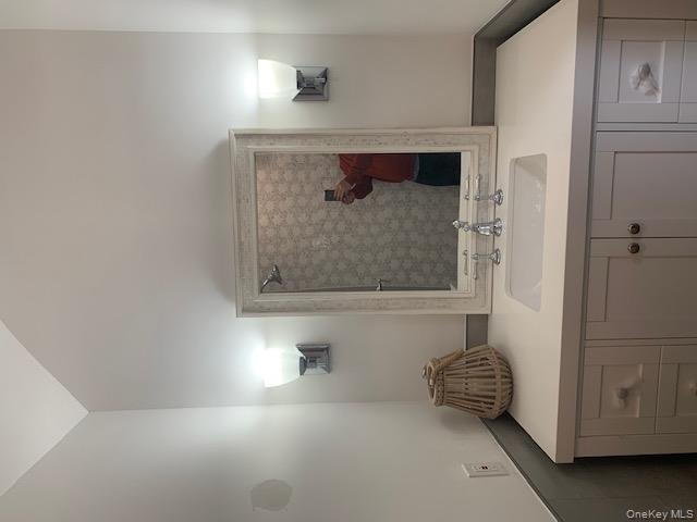 42 Towd Point Road Southampton, NY 11968 - Photo 14 of 26 a bathroom with a sink and a mirror