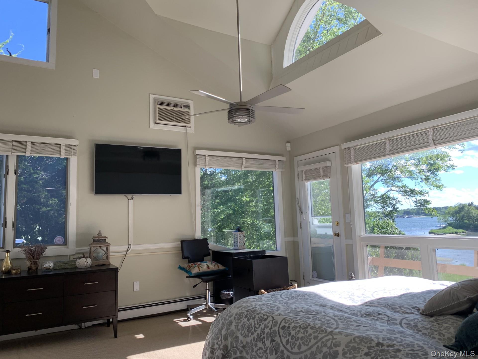 42 Towd Point Road Southampton, NY 11968 - Photo 8 of 26 a bedroom with a large bed and a window