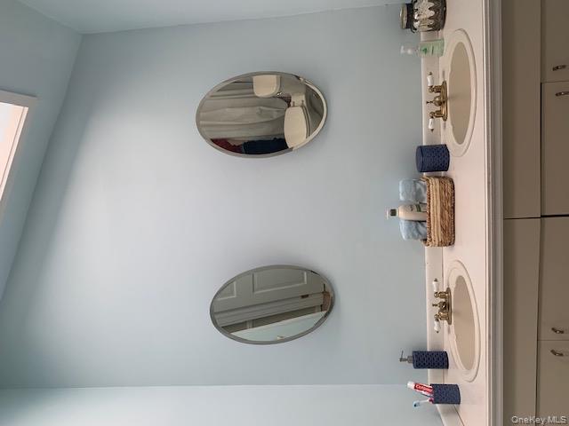 42 Towd Point Road Southampton, NY 11968 - Photo 10 of 26 a bathroom with a sink and a mirror