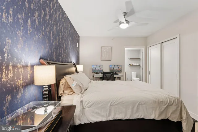 a bedroom with a bed and a lamp