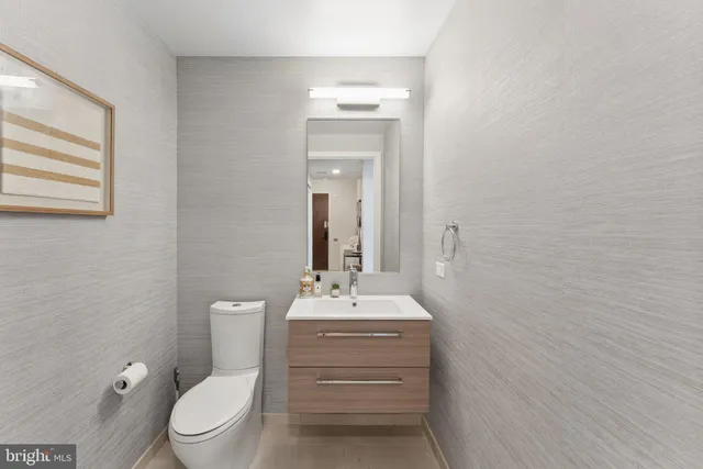 a bathroom with a toilet a sink and mirror