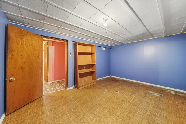 a view of an empty room and wooden floor