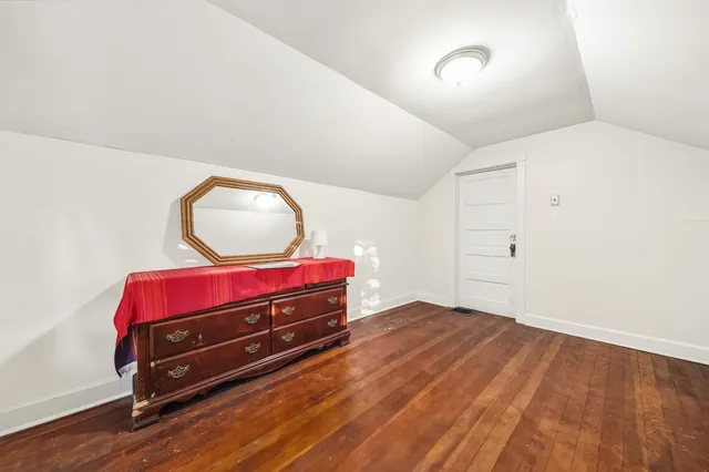 a white toilet sitting next to a white wall