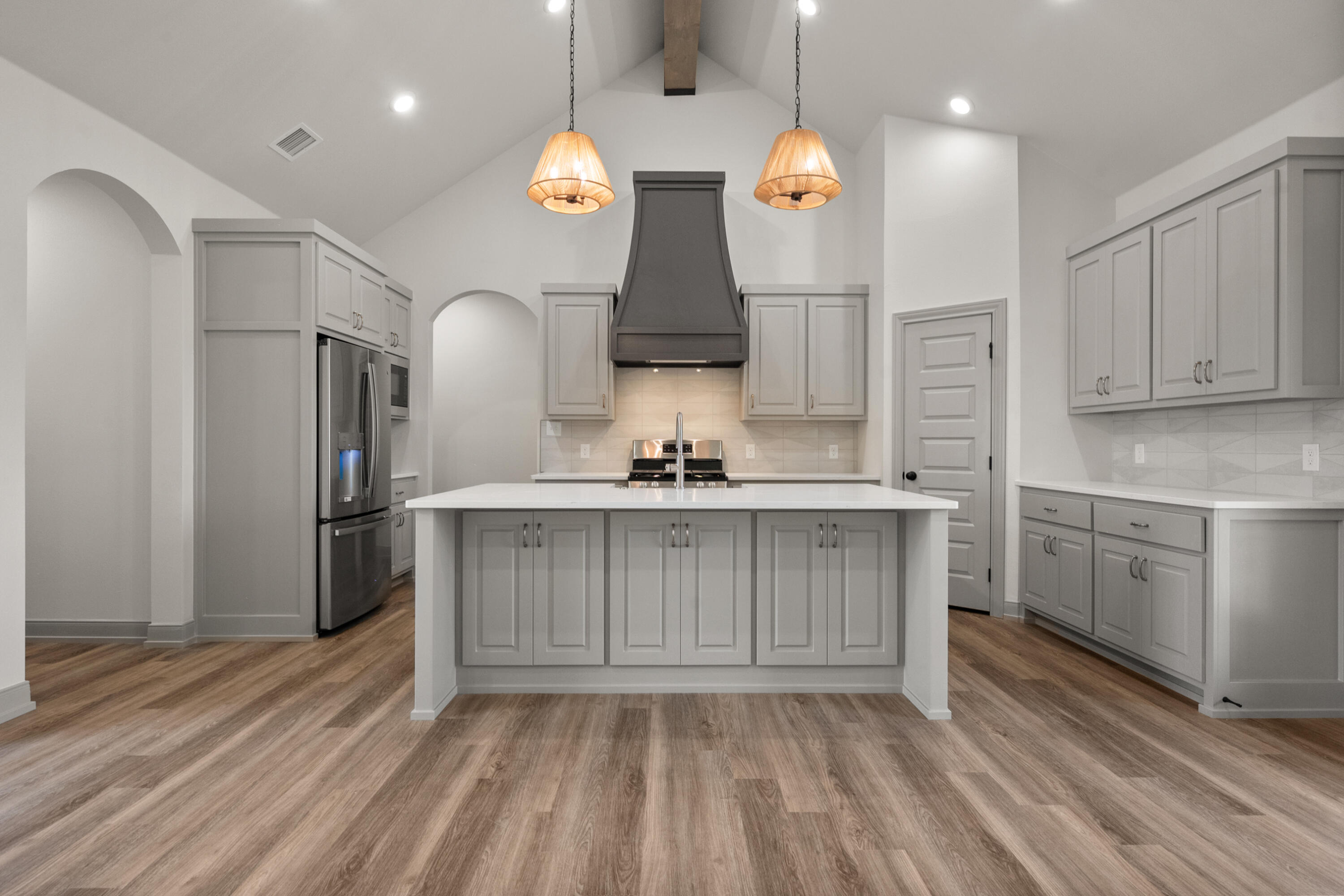 1005 North 5th Street Wolfforth, TX 79382 - Photo 15 of 36 a kitchen with kitchen island granite countertop a sink cabinets and stainless steel appliances