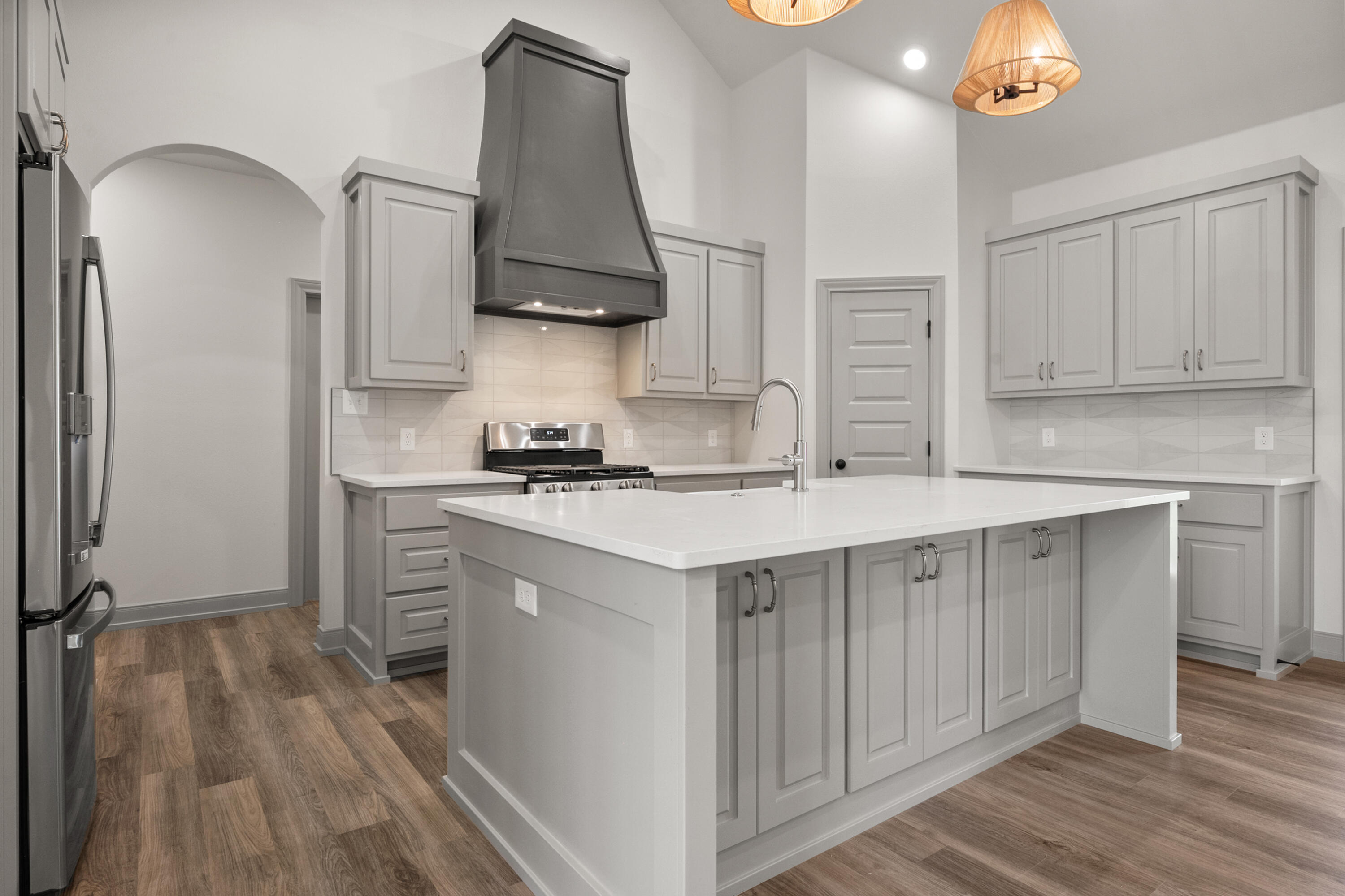 1005 North 5th Street Wolfforth, TX 79382 - Photo 17 of 36 a kitchen with stainless steel appliances a sink stove and refrigerator