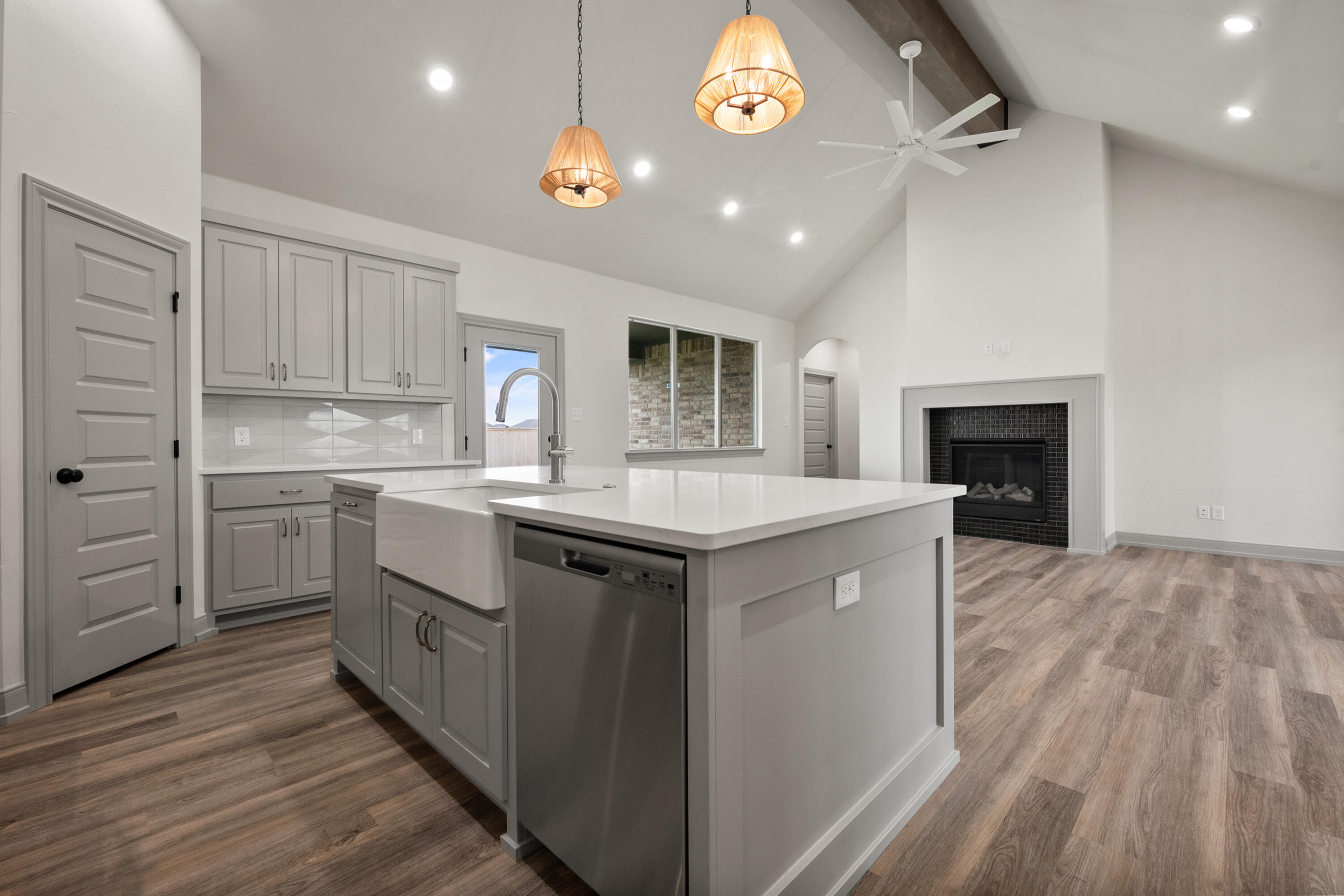 1005 North 5th Street Wolfforth, TX 79382 - Photo 18 of 36 a kitchen with a sink cabinets and wooden floor