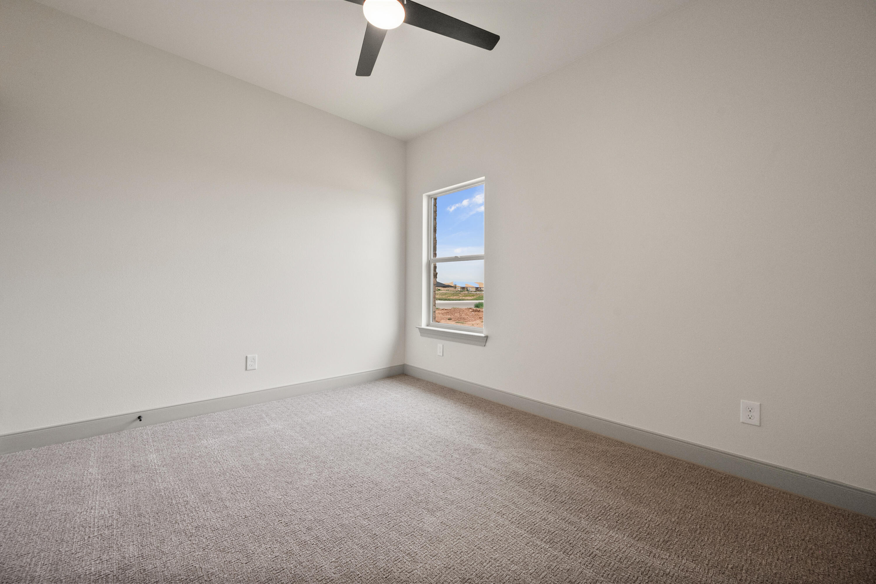 1005 North 5th Street Wolfforth, TX 79382 - Photo 22 of 36 an empty room with a empty space and a ceiling fan