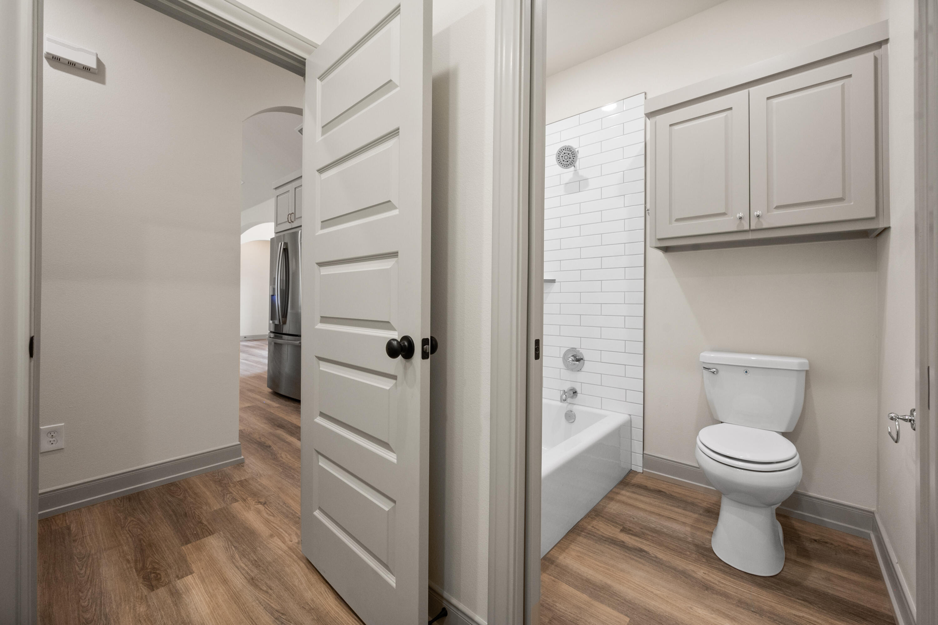 1005 North 5th Street Wolfforth, TX 79382 - Photo 24 of 36 a bathroom with a toilet and a shower