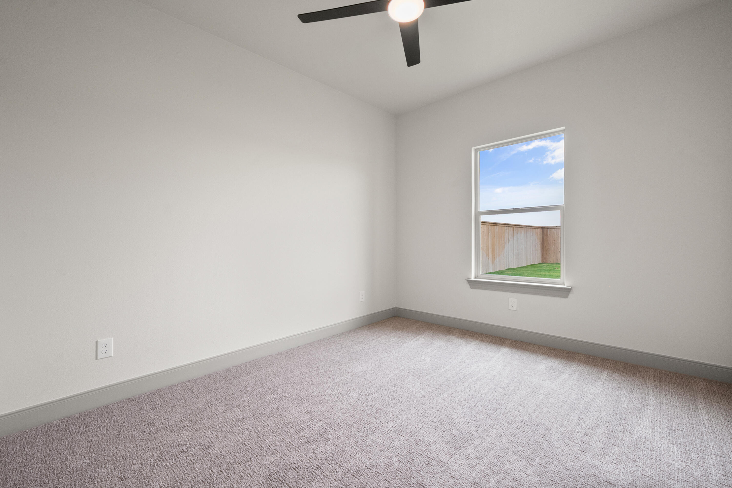 1005 North 5th Street Wolfforth, TX 79382 - Photo 25 of 36 an empty room with a window and ceiling fan