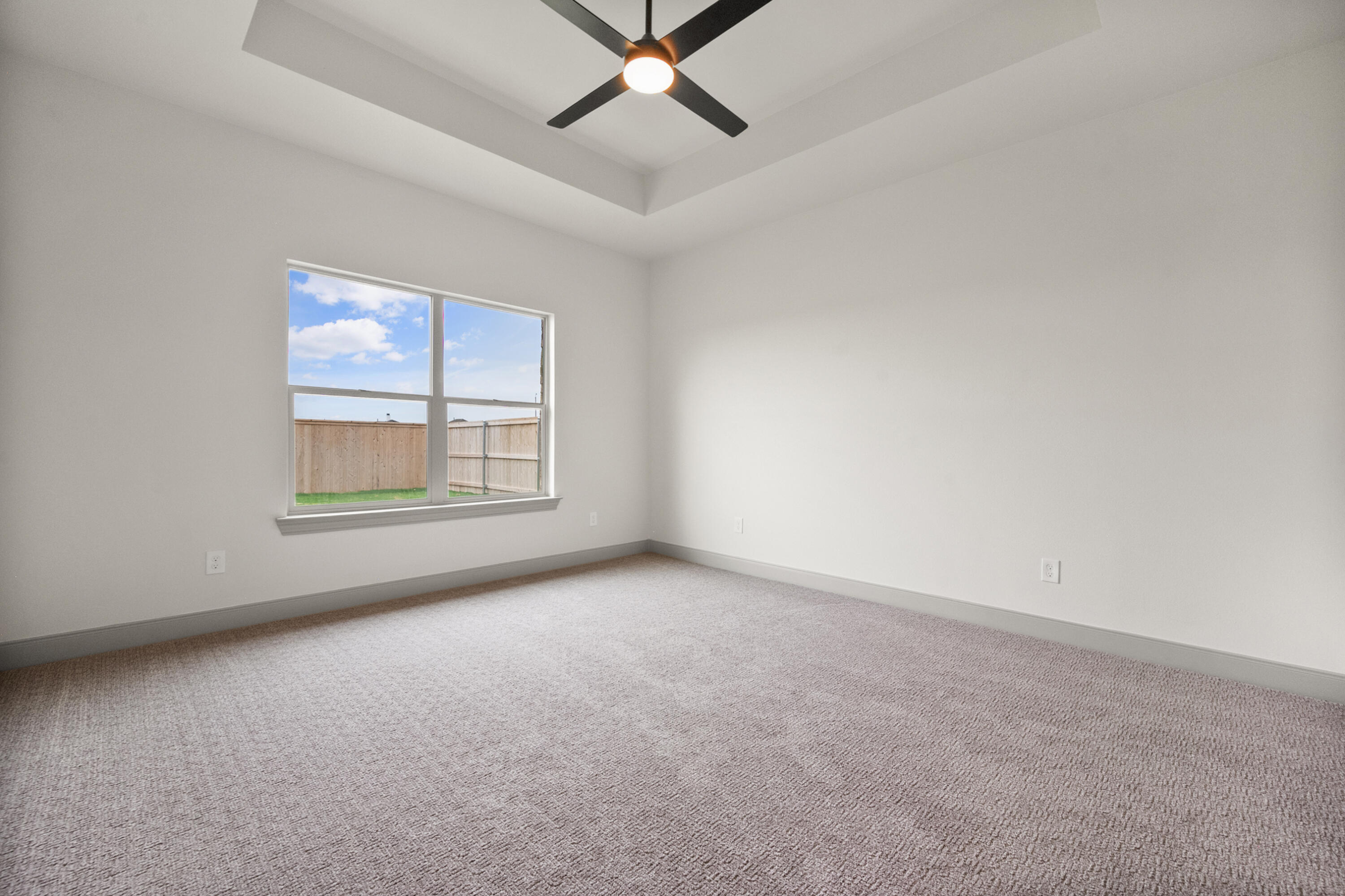 1005 North 5th Street Wolfforth, TX 79382 - Photo 26 of 36 an empty room with windows and fan