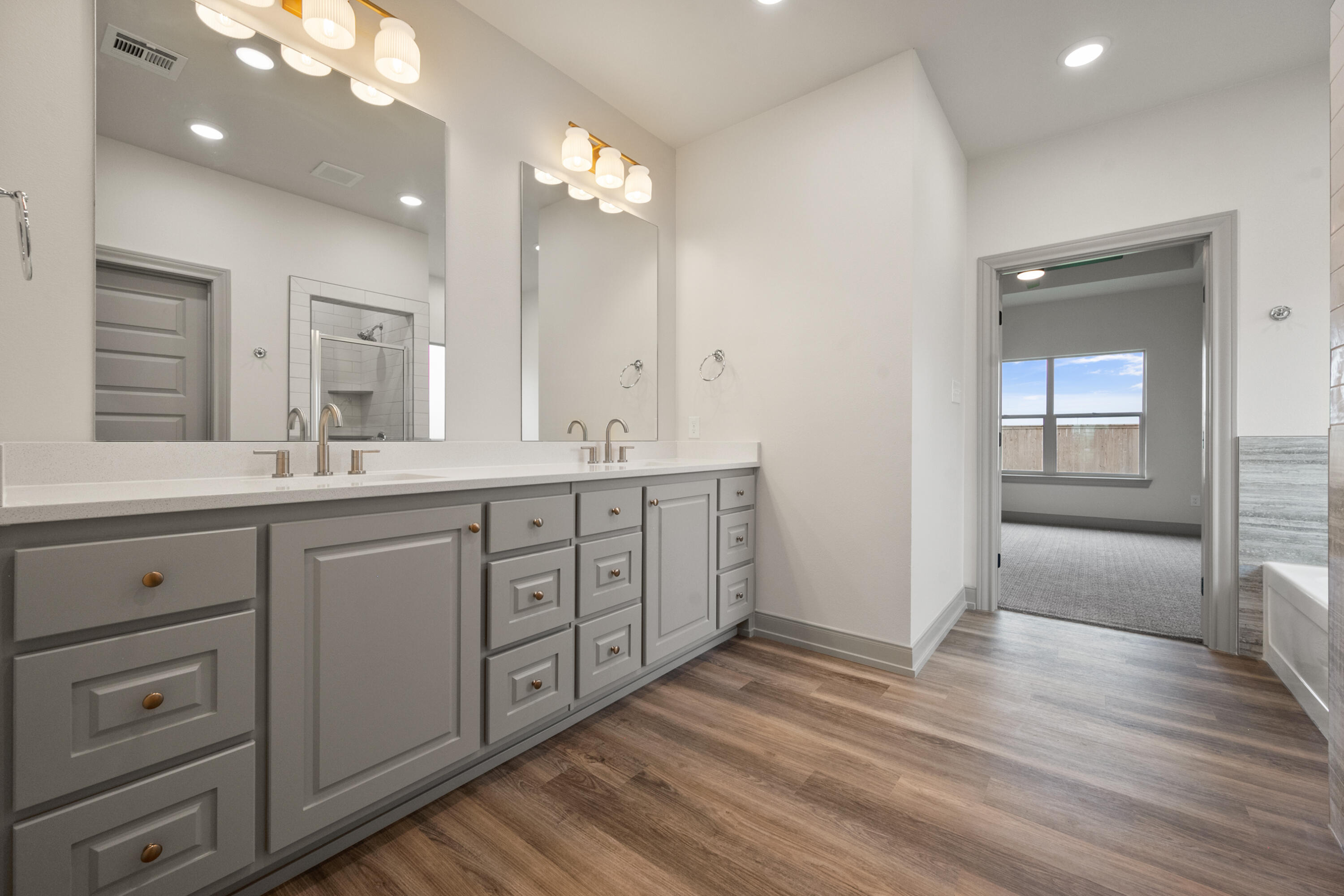 1005 North 5th Street Wolfforth, TX 79382 - Photo 32 of 36 a spacious bathroom with double sink large mirror and next to a window