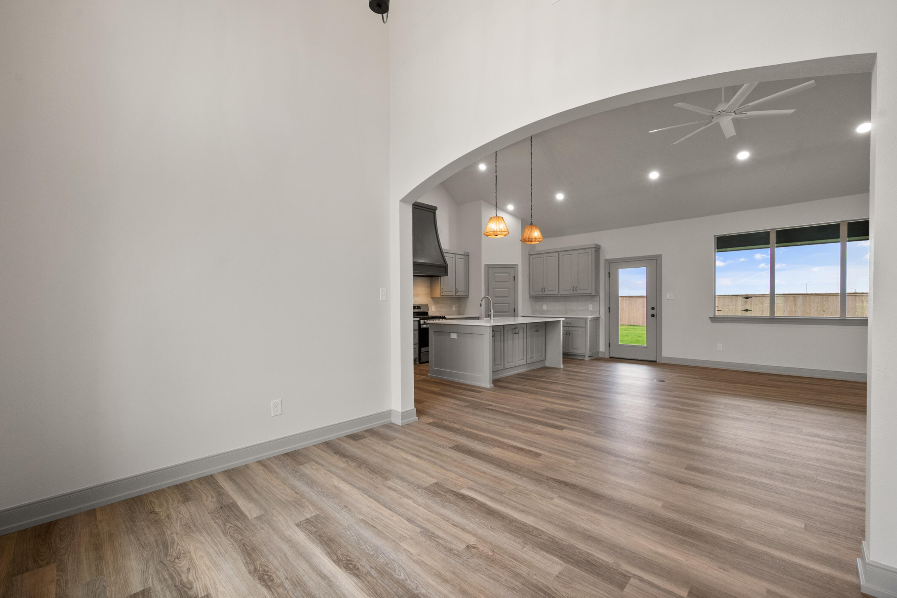 1005 North 5th Street Wolfforth, TX 79382 - Photo 8 of 36 a view of kitchen and hall with wooden floor