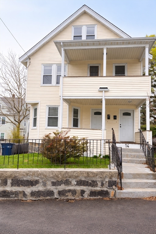 14 Walter Street, Unit 1 Boston, MA 02131 - Photo 1 of 14 a front view of a house with a garden