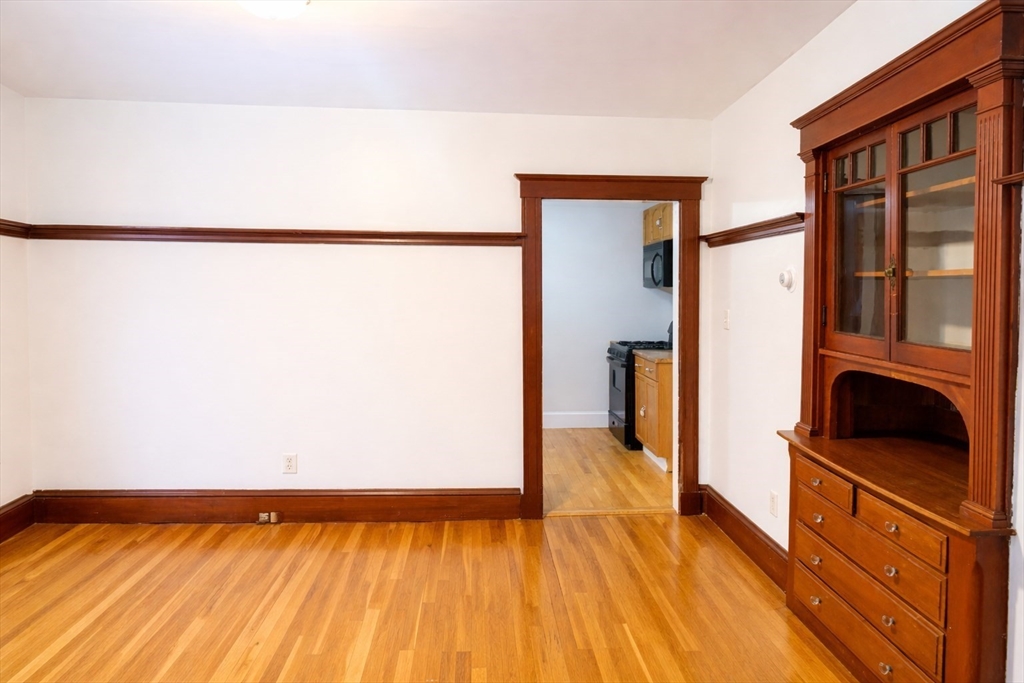 14 Walter Street, Unit 1 Boston, MA 02131 - Photo 4 of 14 a view of a living room with a bed and wooden floor