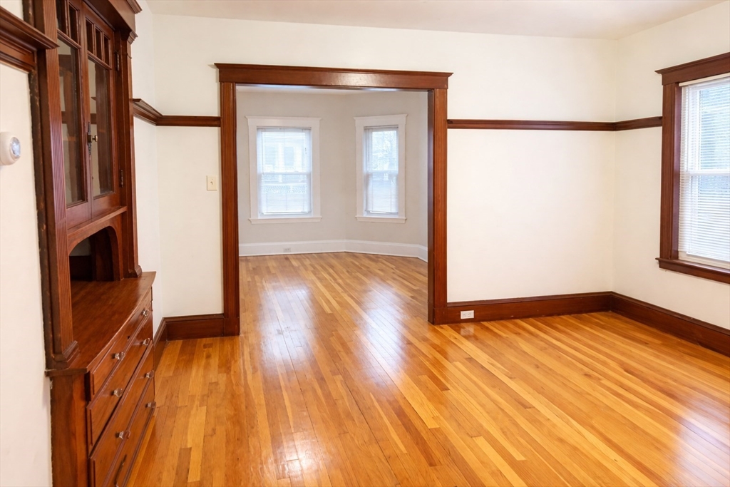 14 Walter Street, Unit 1 Boston, MA 02131 - Photo 5 of 14 a view of an empty room with wooden floor and a window