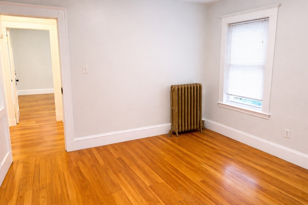 14 Walter Street, Unit 1 Boston, MA 02131 - Photo 9 of 14 a view of a livingroom with wooden floor and a window