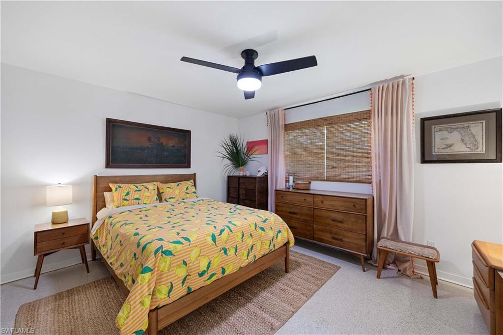 1304 Milano Drive Naples, FL 34103 - Photo 11 of 37 a bed room with a bed and a window