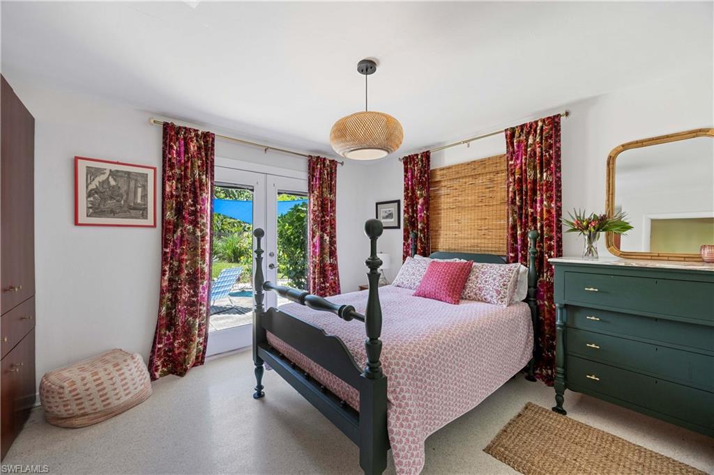 1304 Milano Drive Naples, FL 34103 - Photo 14 of 37 a bedroom with a bed and a chandelier