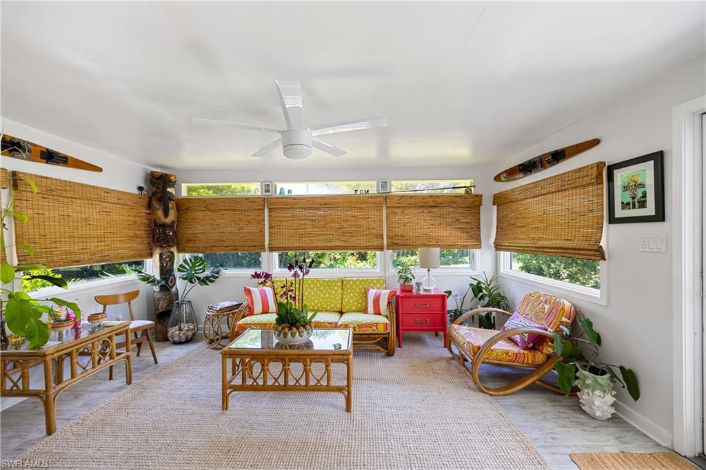 1304 Milano Drive Naples, FL 34103 - Photo 17 of 37 a living room with furniture toys and a large window