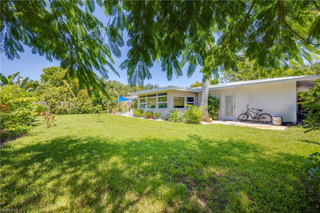 1304 Milano Drive Naples, FL 34103 - Photo 30 of 37 a front view of a house with garden