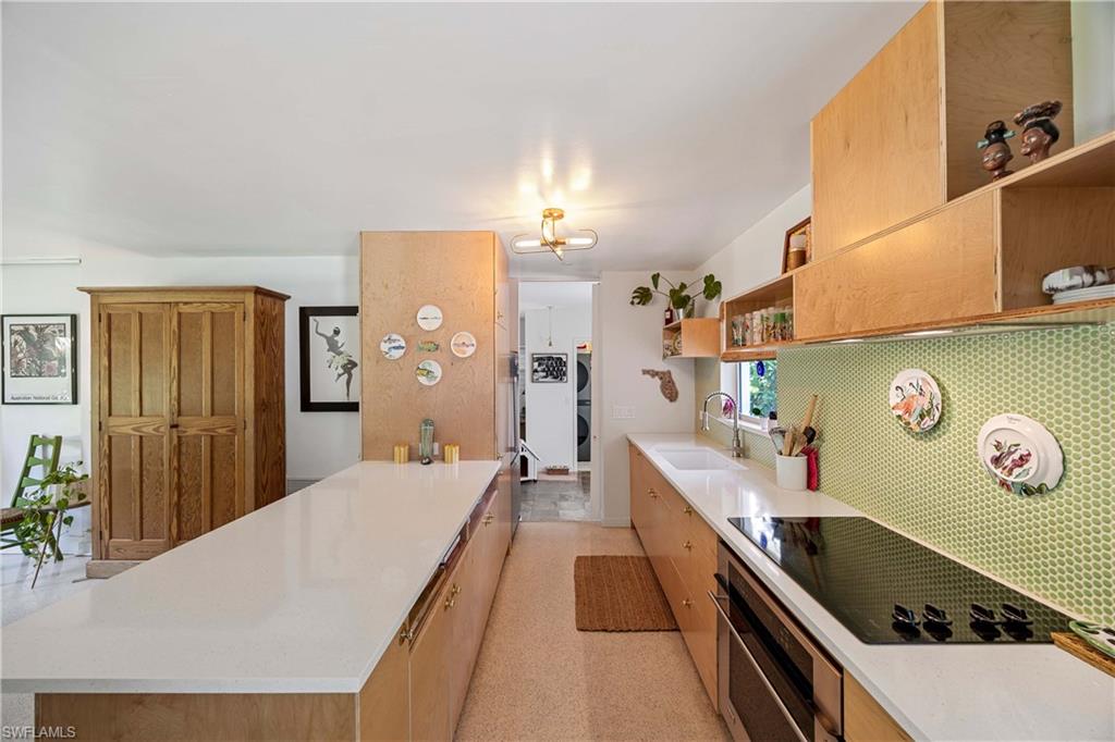 1304 Milano Drive Naples, FL 34103 - Photo 3 of 37 a dining room with stainless steel appliances kitchen island a stove and a refrigerator