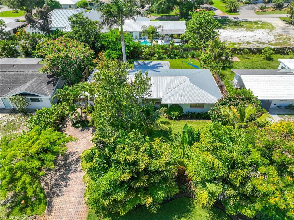 1304 Milano Drive Naples, FL 34103 - Photo 34 of 37 an aerial view of residential house with outdoor space and trees all around