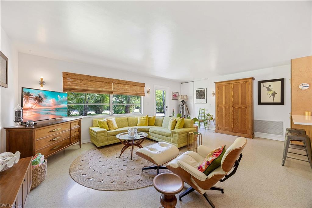 1304 Milano Drive Naples, FL 34103 - Photo 9 of 37 a living room with furniture and a large window