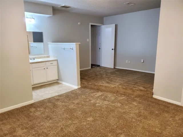 a view of a kitchen with white cabinets