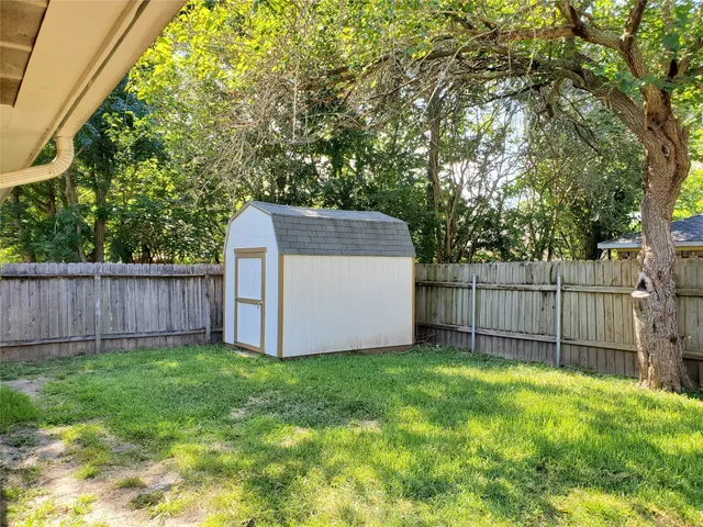 a view of a backyard with a house and wooden fence