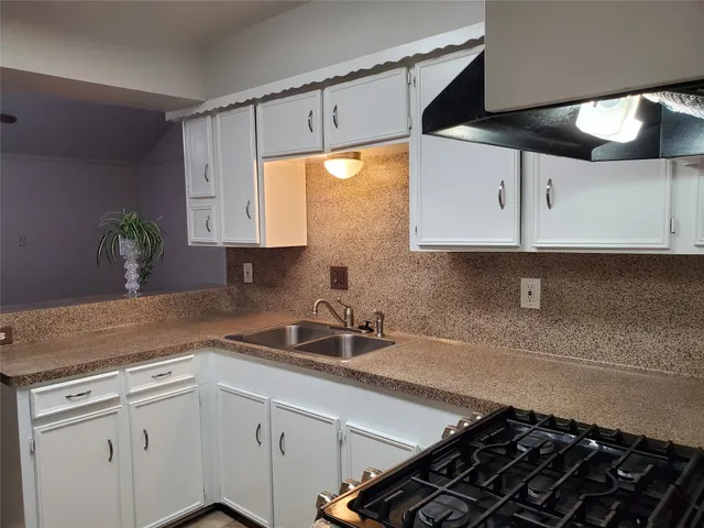 a kitchen with a sink and cabinets
