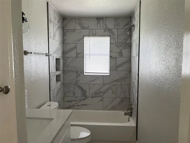 a bathroom with a tub and a shower