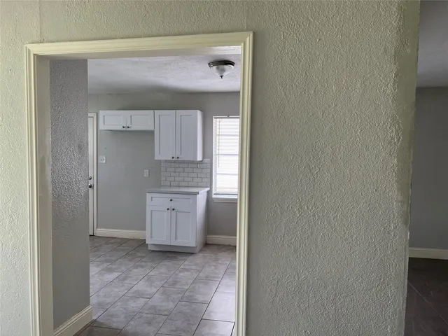 a bathroom with a granite countertop sink and mirror