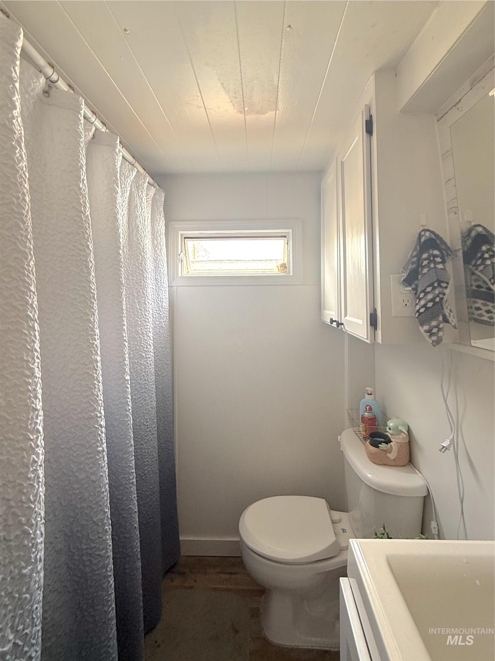6728 West Fairview Avenue, Unit 24 Boise, ID 83704 - Photo 9 of 9 Full bathroom with a shower with shower curtain, vanity, and dark wood finished floors