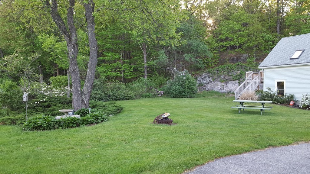 76 Randall Road Berlin, MA 01503 - Photo 4 of 29 a backyard of a house with table and chairs