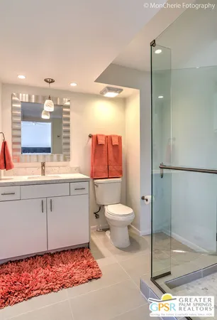 a bathroom with a glass shower door and a glass door