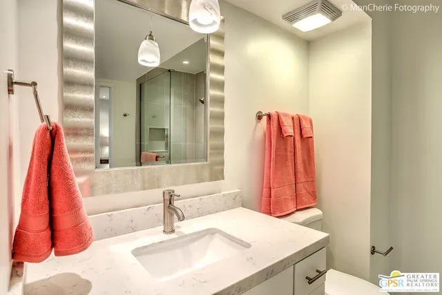 a bedroom with a bed and a mirror