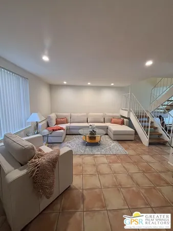 a living room with furniture and a projector screen