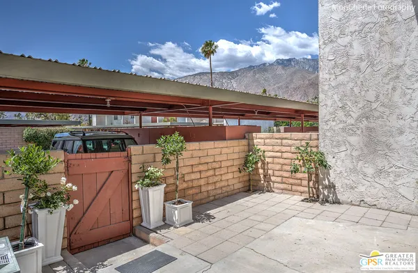 a view of swimming pool with outdoor seating and plants