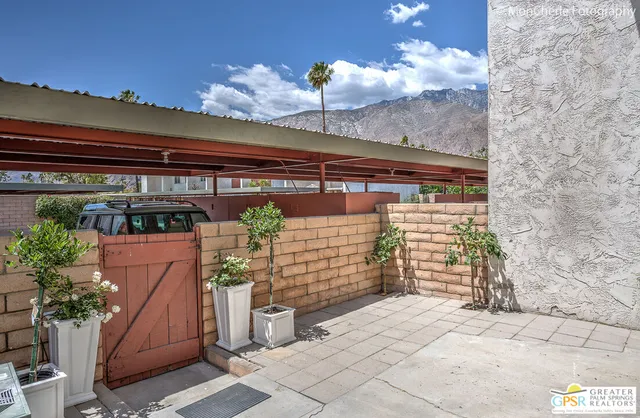 a view of swimming pool with outdoor seating and plants