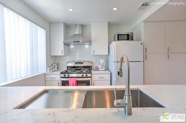 a large white bed sitting in a bedroom