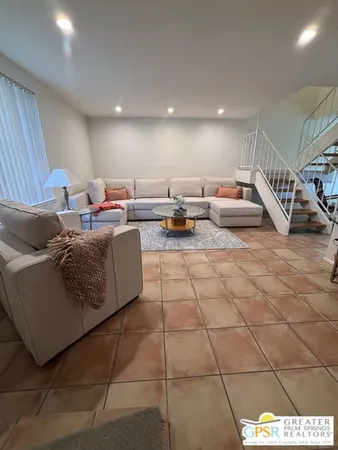 a living room with furniture and a rug