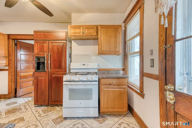 a kitchen with stainless steel appliances granite countertop a refrigerator and a stove