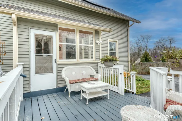a view of a deck with table and chairs and wooden floor
