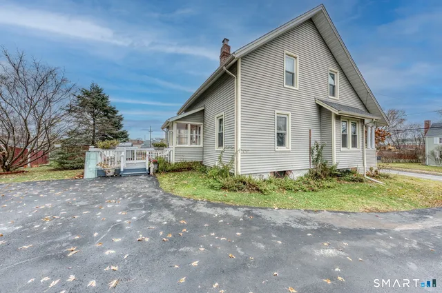 a view of a house with a yard and garage